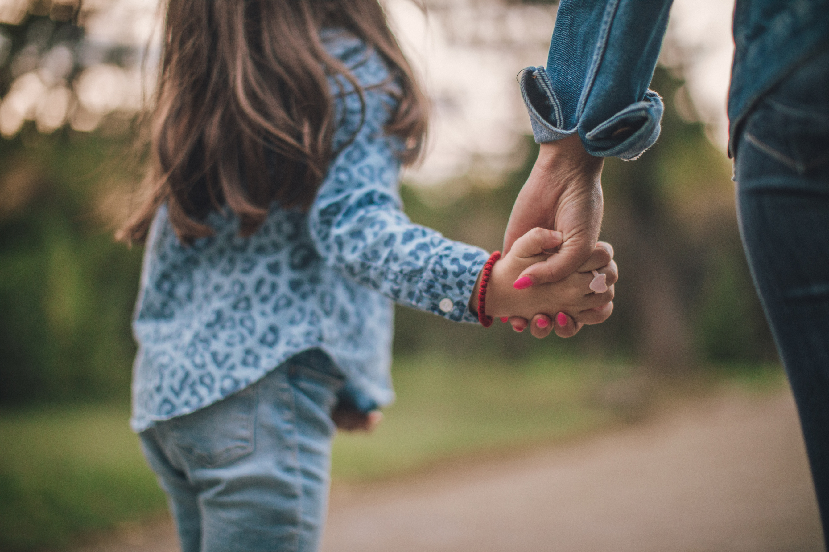 Mother and daughter holding hands