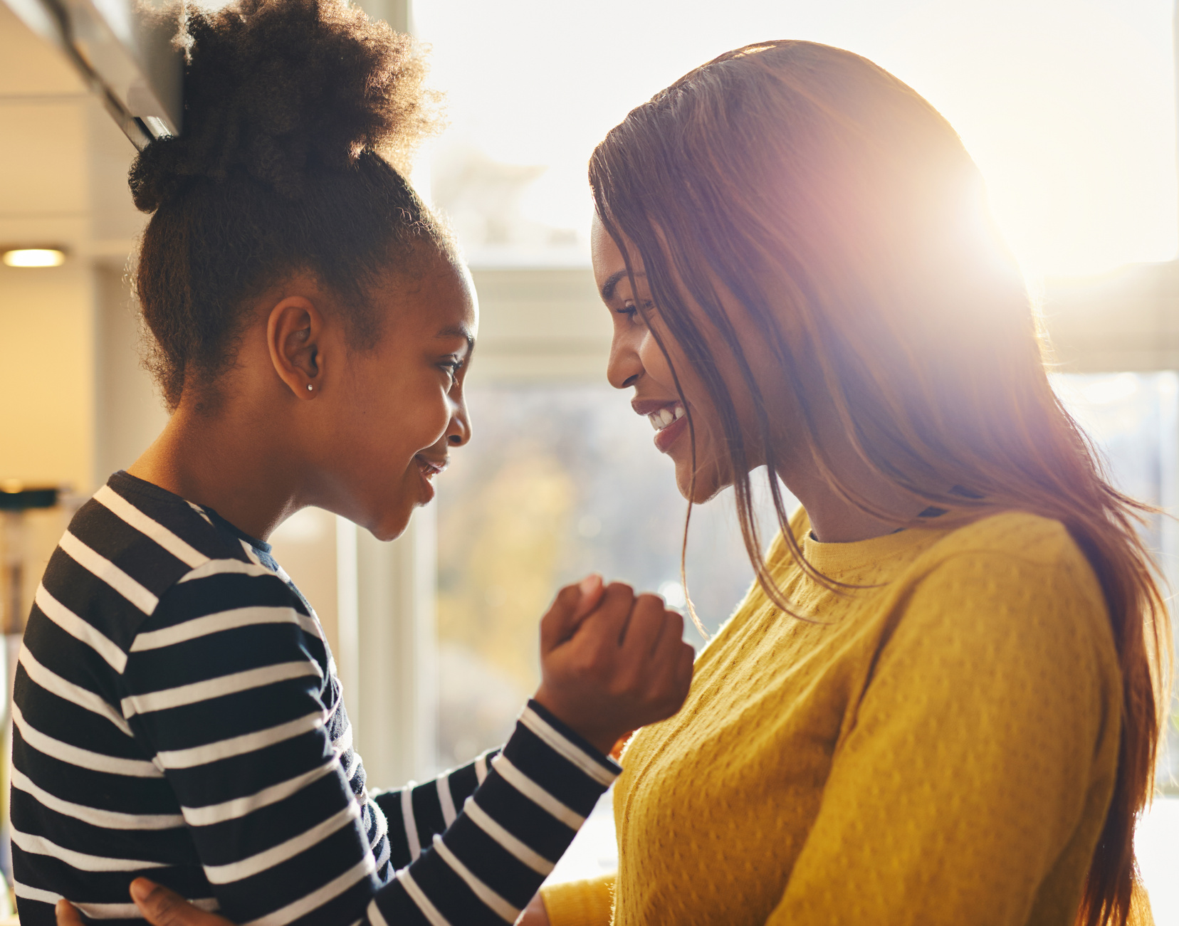 Mom and Daughter Smiling at Each Other